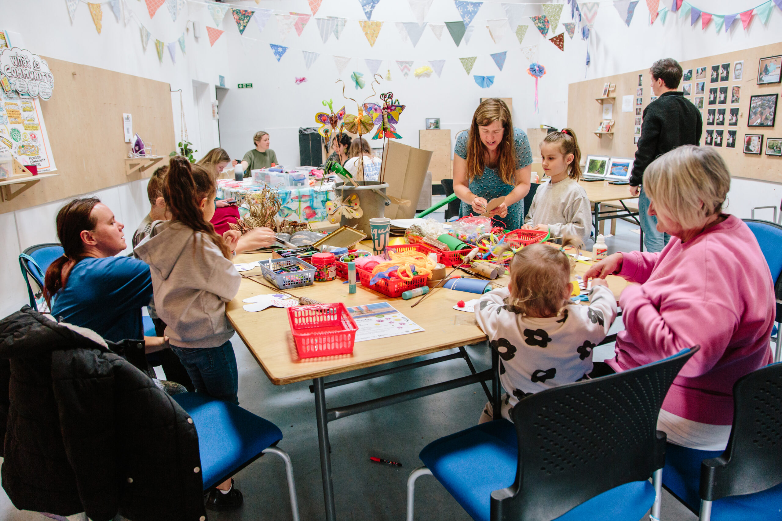 children and adults doing crafts around a table